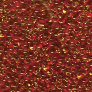 A Pile of Red Lined Light Topaz Drop Beads